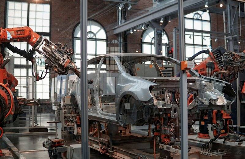 Robotic arms assembling car bodies on an automotive production line