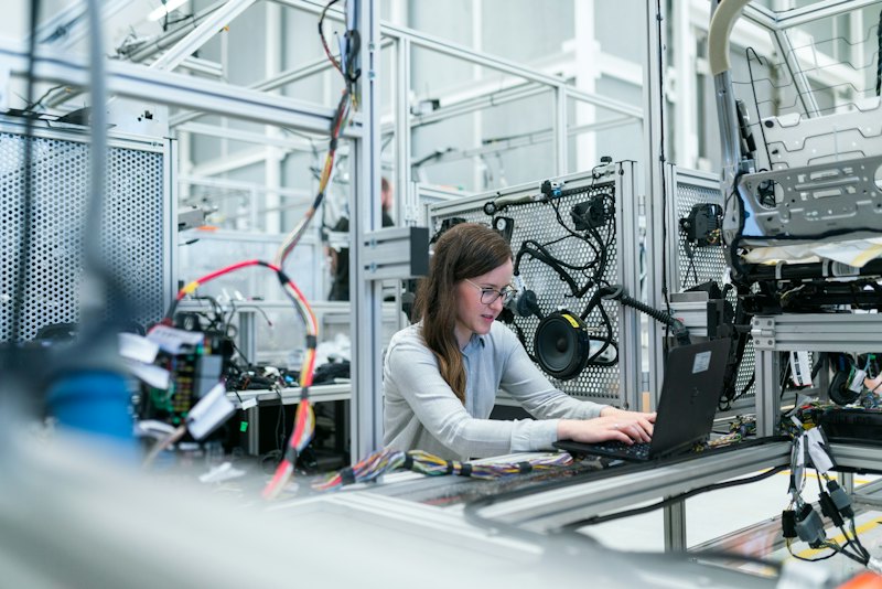 Engineer working on a laptop in an industrial electronics lab