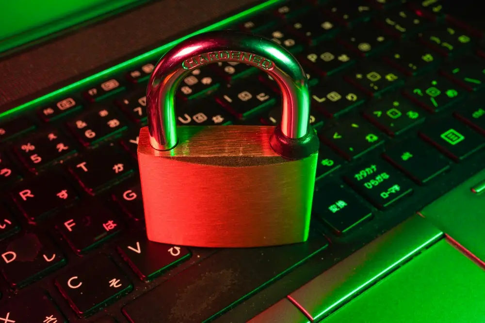 Padlock resting on a backlit laptop keyboard