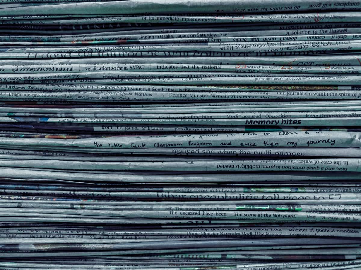 A tall stack of folded newspapers seen from the side