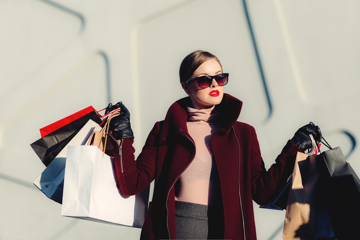 A fashion customer carrying shopping bags from multiple purchases
