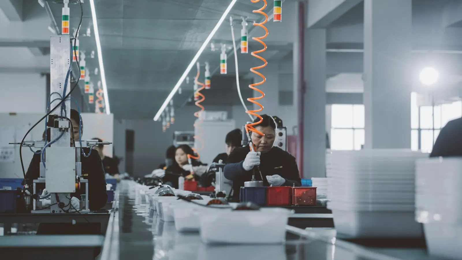 Operators working at stations on a factory production line