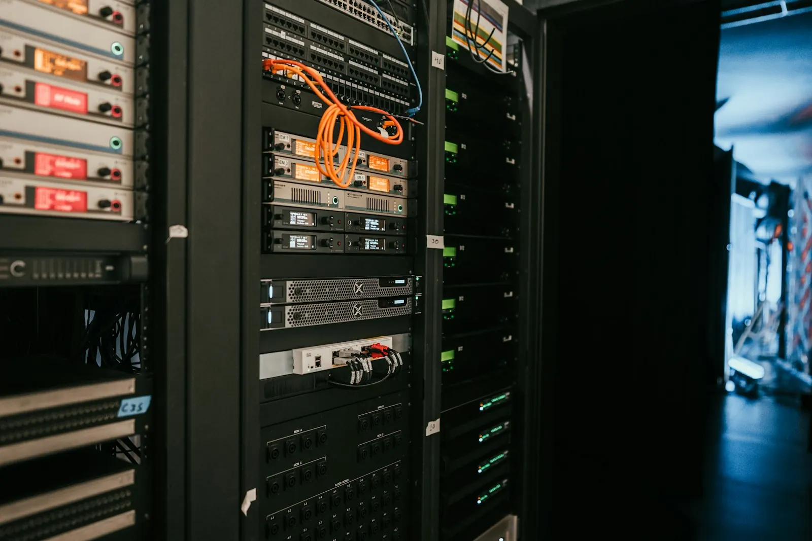 Rack of on-premise servers with network cabling in a server room