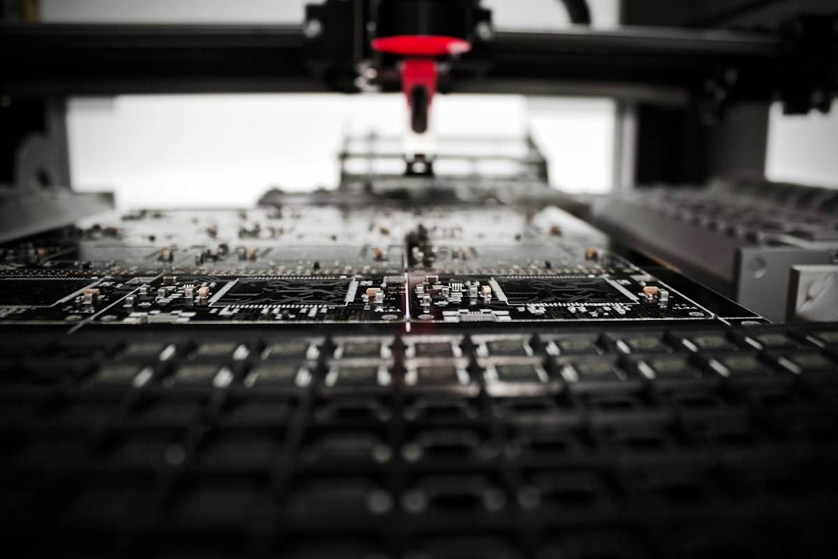 Vision-inspection hardware positioned over a circuit board on a production line